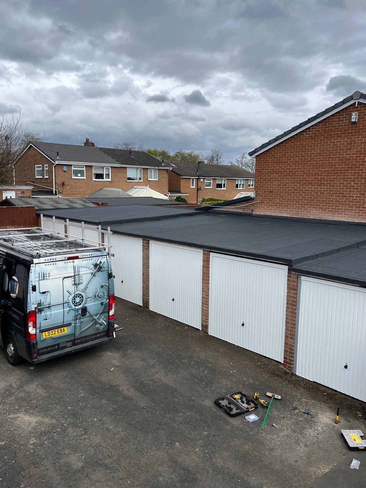 New black felt flat roofs on a block of garages &mdash; Ackroyd & Son Roofing commercial project